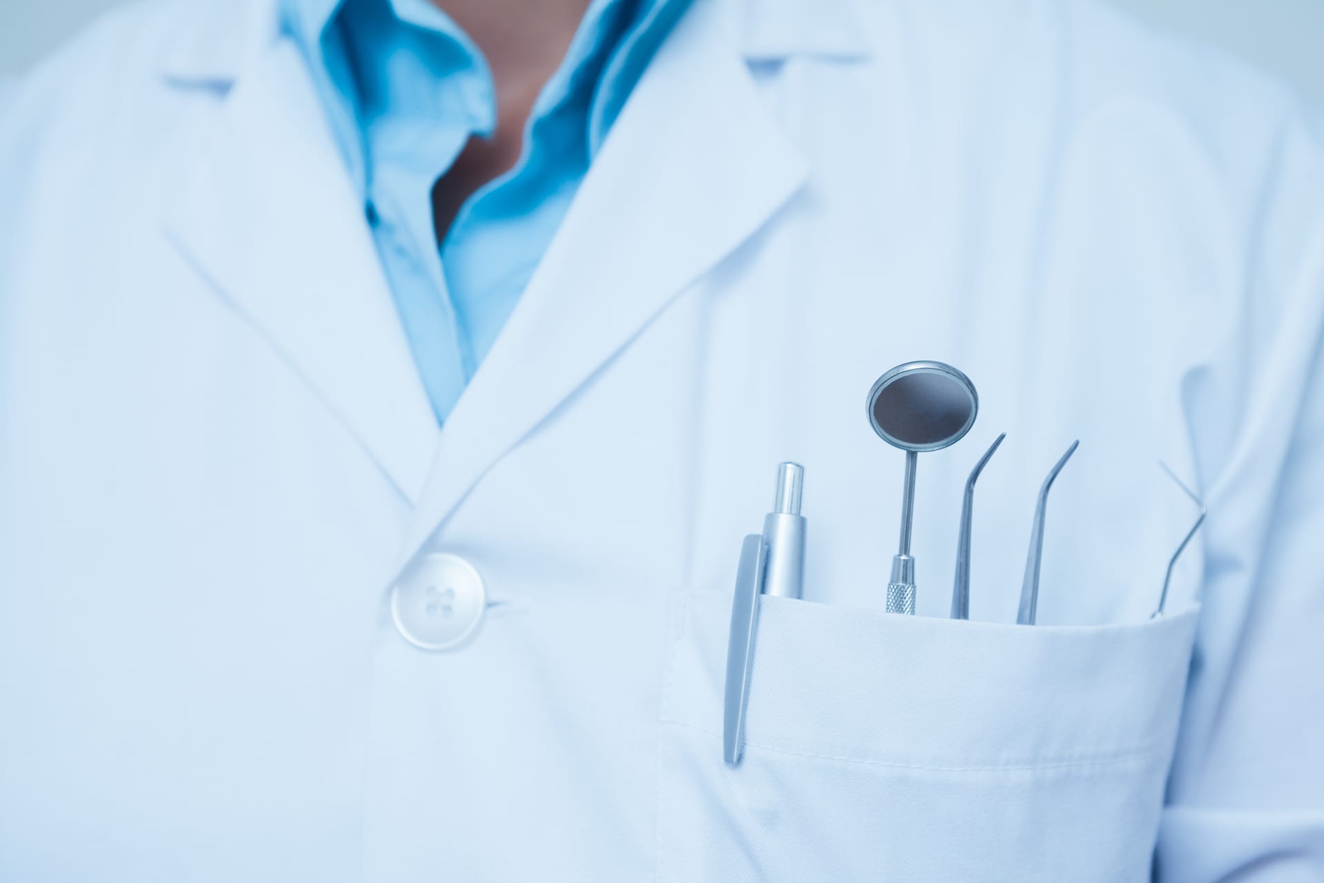 Dental instruments in the pocket of a lab coat